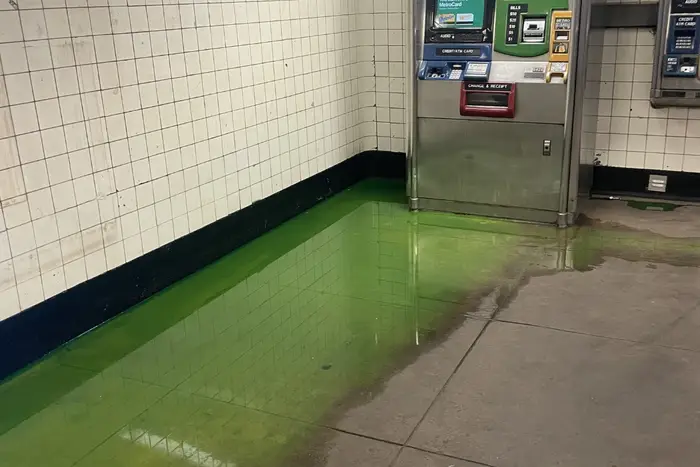 A photo of green ooze at a city subway stop